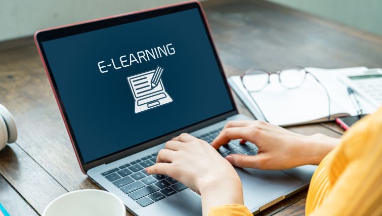 Corporate e-learning Strategies for Employee Training and Development - a work laptop with e-learning on the screening.