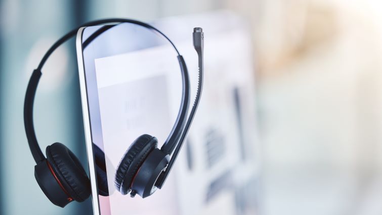 Mastering the Call Center Job Interview - a headset resting on the work station in a call center.