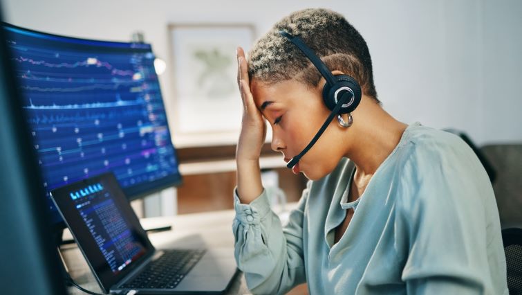 How Do You Prevent Customer Service Burnout? - a customer service rep looking tired at their desk.