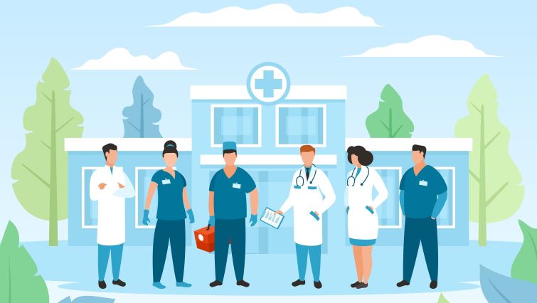 Top Skills Employers Look for in Healthcare Workers - a team of healthcare workers standing in front of a hospital.